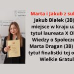 Grafika zawiera zdjęcie dwojga młodych ludzi, prawdopodobnie uczniów szkoły średniej, stojących na tle ścianki z logo Wydziału Prawa Uniwersytetu w Białymstoku. Po lewej stronie stoi chłopak o średniej długości jasnobrązowych włosach, ubrany w białą koszulę i ciemną kamizelkę. W rękach trzyma złoty puchar i delikatnie się uśmiecha. Obok niego, po prawej stronie, stoi dziewczyna o długich jasnobrązowych włosach, ubrana w czarną marynarkę. W rękach trzyma zaświadczenie o udziale w olimpiadzie i uśmiecha się lekko. Na grafice znajduje się również tekst z gratulacjami dla uczniów: Marta i Jakub z sukcesami! Jakub Białek (3B) zajął 6 miejsce w kraju, uzyskując tytuł laureata X Olimpiady Wiedzy o Społeczeństwie. Marta Dragan (3B) uzyskała tytuł finalistki tej olimpiady. Wielkie Gratulacje!