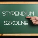 Obraz przedstawia ciemnozieloną szkolną tablicę w drewnianej ramie, umieszczoną na czarnym tle. W centrum tablicy znajduje się biały, prosty, nowoczesny napis pisany wielkimi literami: „STYPENDIUM SZKOLNE”. Dodatkowe elementy: Po prawej stronie obrazu, na wysokości napisu, widoczna jest ludzka dłoń z jasną karnacją, ułożona poziomo z wyprostowanym palcem wskazującym, który wskazuje bezpośrednio na napis „STYPENDIUM”. Tło poza tablicą jest całkowicie czarne, co podkreśla kontrast i skupia uwagę na napisie. Symbolika i kontekst: Obraz w wyraźny sposób wskazuje na temat pomocy finansowej dla uczniów – stypendium szkolne. Użycie szkolnej tablicy i gestu wskazującego ma za zadanie zwrócić uwagę odbiorcy na ważność tematu.